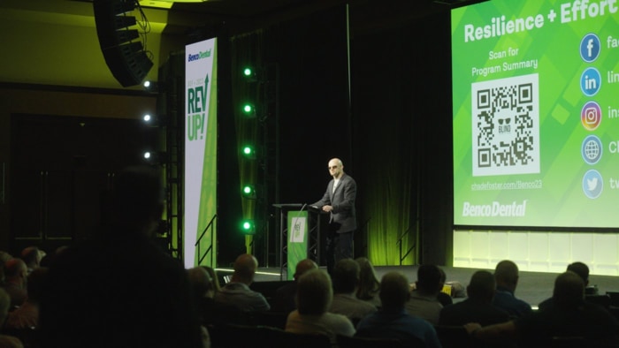 Chad E. Foster on stage delivering keynote presentation