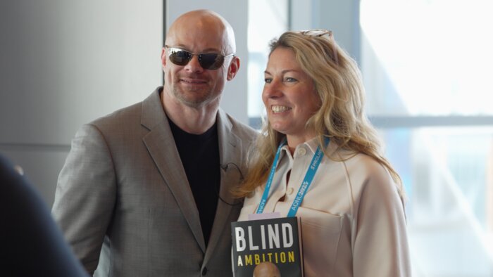 Chad E Foster with female attendee and Blind Ambition book at Boston AONL