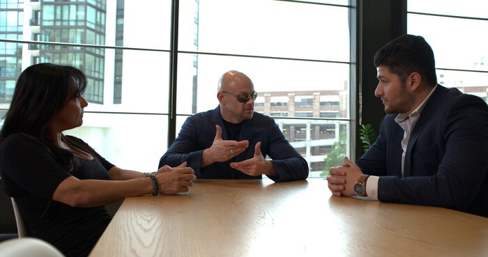 Corporate meeting medium shot with Chad E Foster leading business discussion